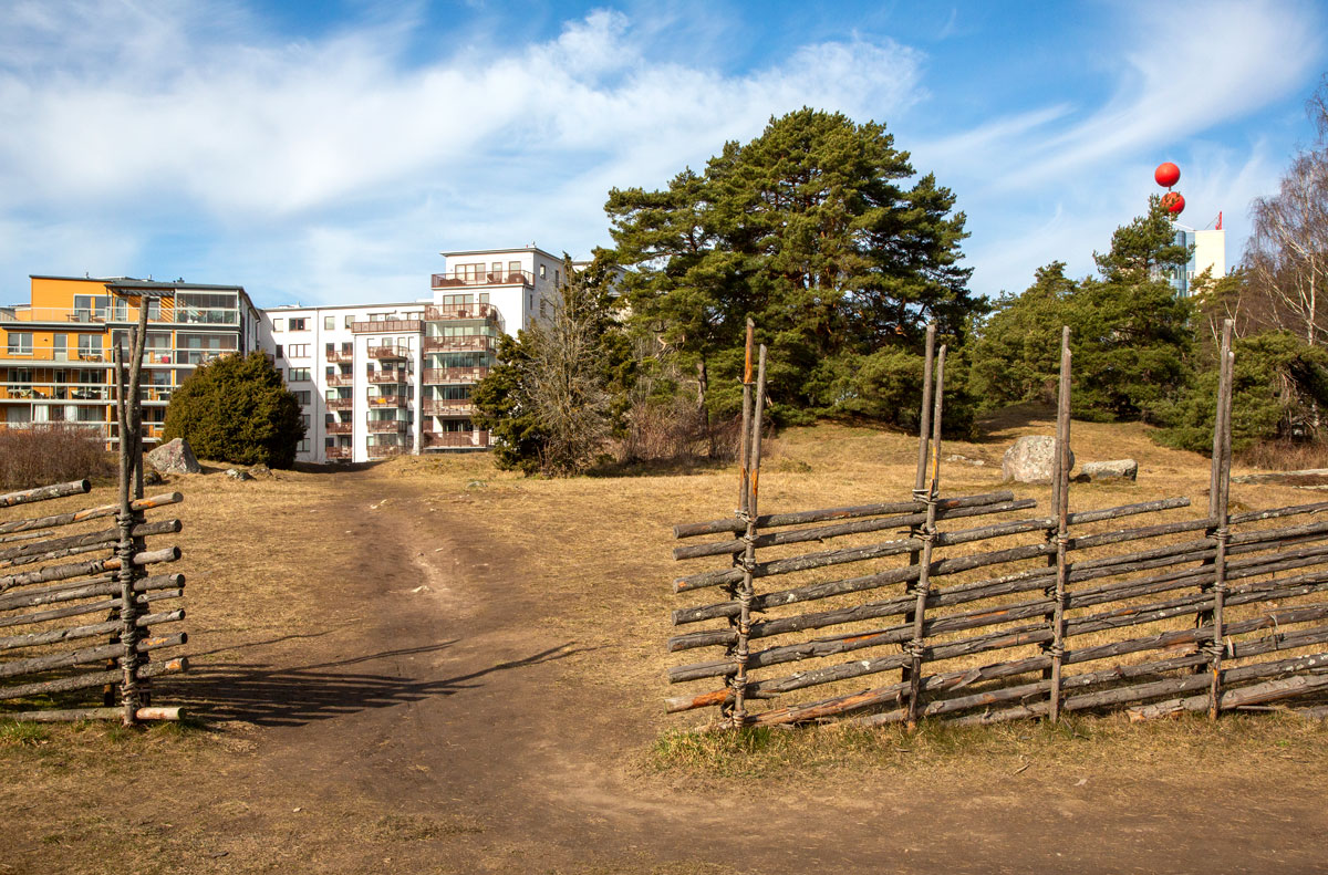 Foto. Gärdesgård utanför bostadshus.